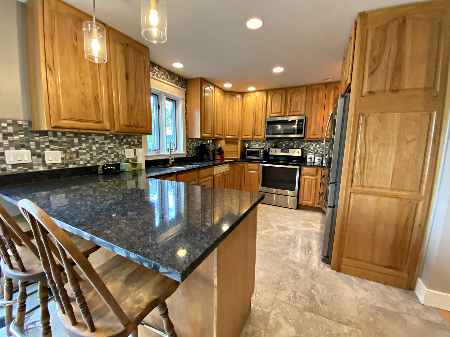 8101 Greenwood Road Hebron, IL 60034 - Photo 15 of 39 a kitchen with stainless steel appliances granite countertop a sink stove and refrigerator