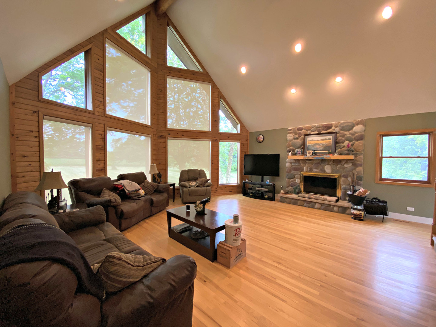 8101 Greenwood Road Hebron, IL 60034 - Photo 8 of 39 a living room with furniture a fireplace and floor to ceiling windows