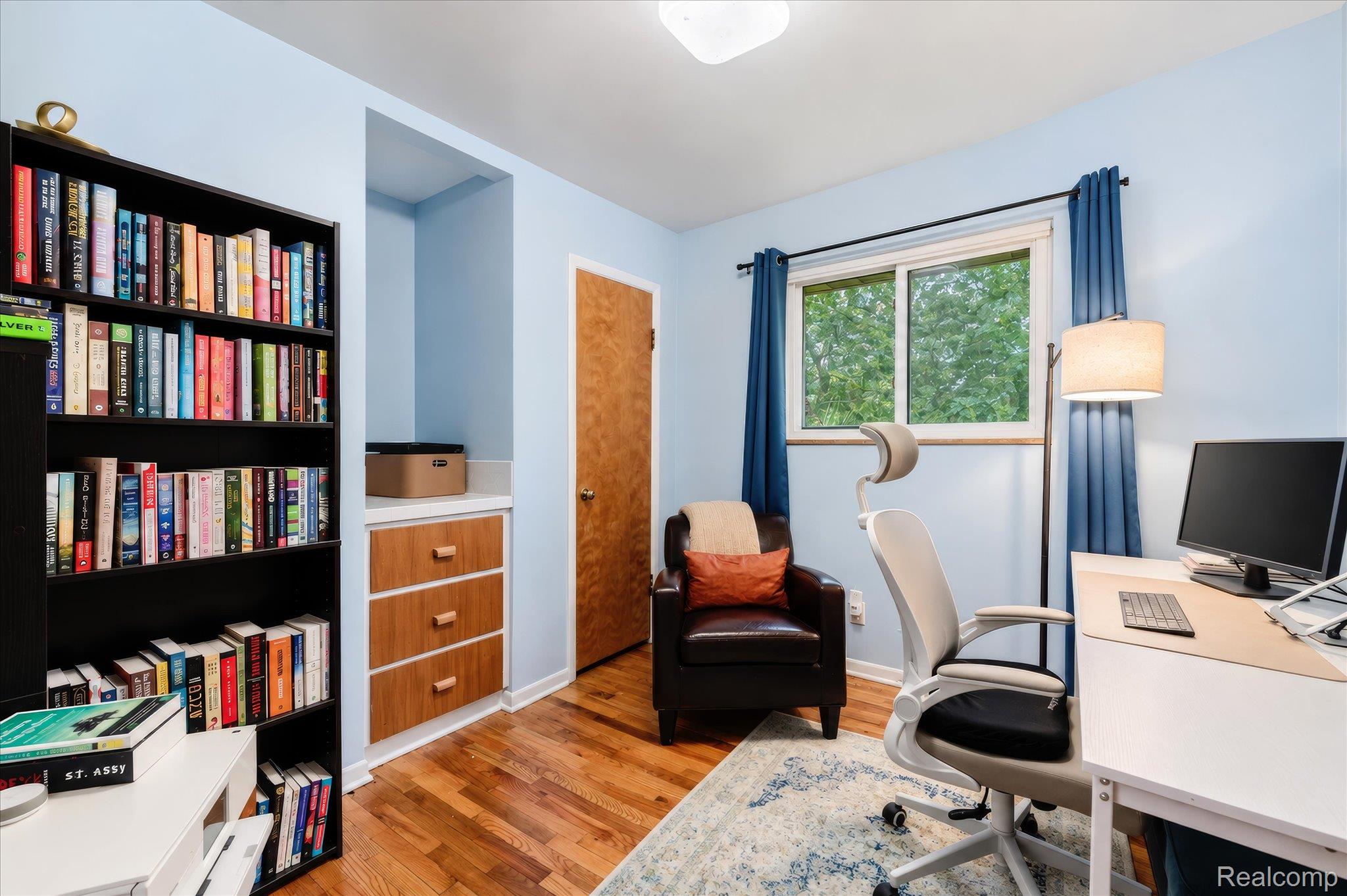 4499 South Linden Road Flint, MI 48507 - Photo 23 of 32 Built-in shelving, wood-finish flooring, and a large window with natural light
