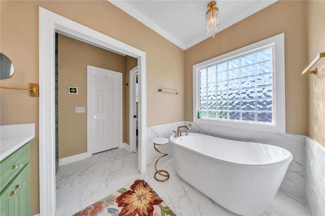 648 Mountain View Road Williamston, SC 29697 - Photo 21 of 42 Relax and unwind in this primary bathroom featuring a freestanding tub and privacy window.