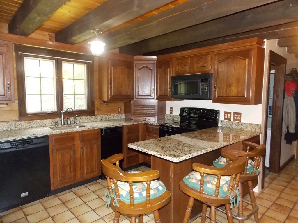 7 Betty Spring Road Freetown, MA 02717 - Photo 3 of 30 a kitchen with a stove a sink and a refrigerator