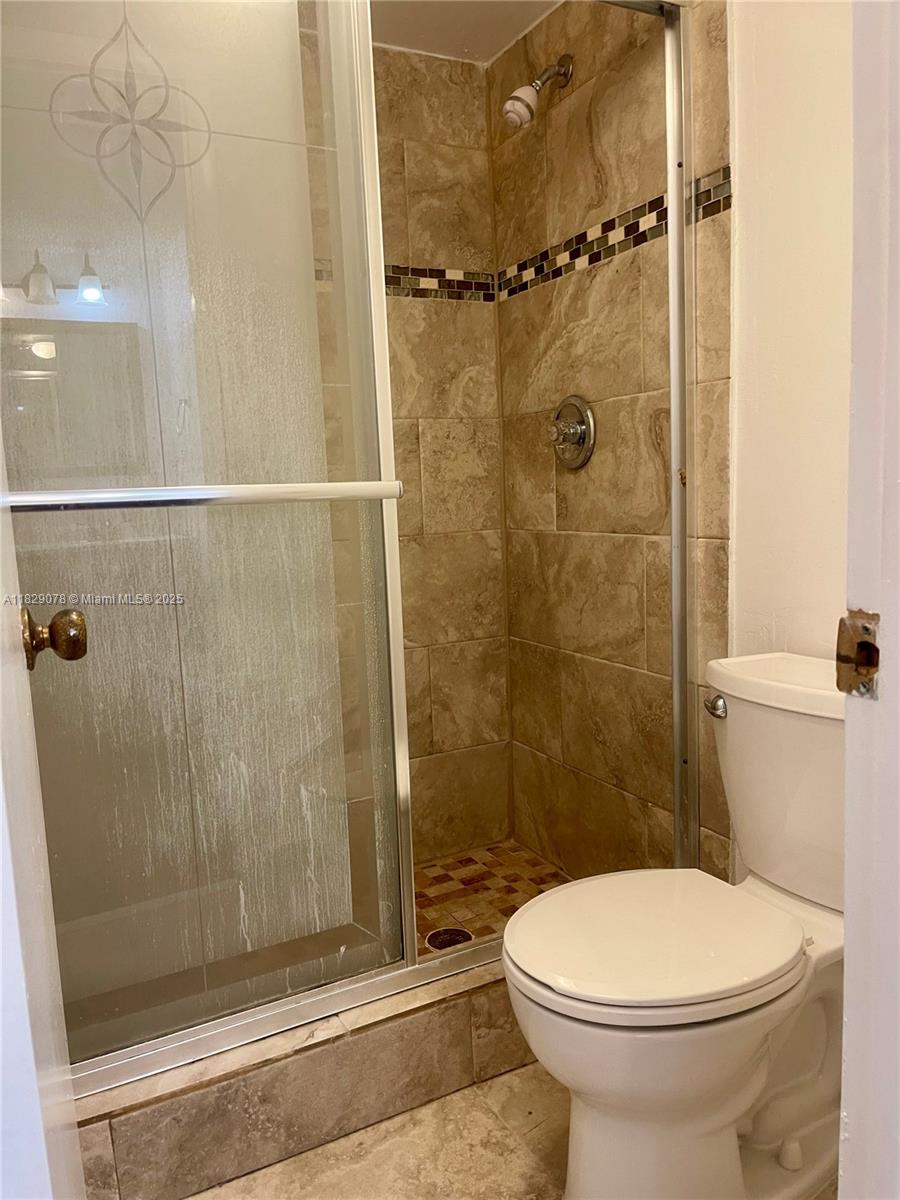 430 Commodore Drive, Unit 301 Plantation, FL 33325 - Photo 15 of 26 a bathroom with a toilet and a shower