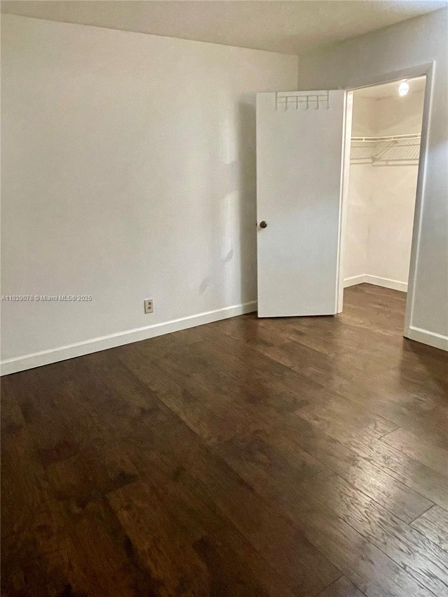 430 Commodore Drive, Unit 301 Plantation, FL 33325 - Photo 18 of 26 an empty room with wooden floor