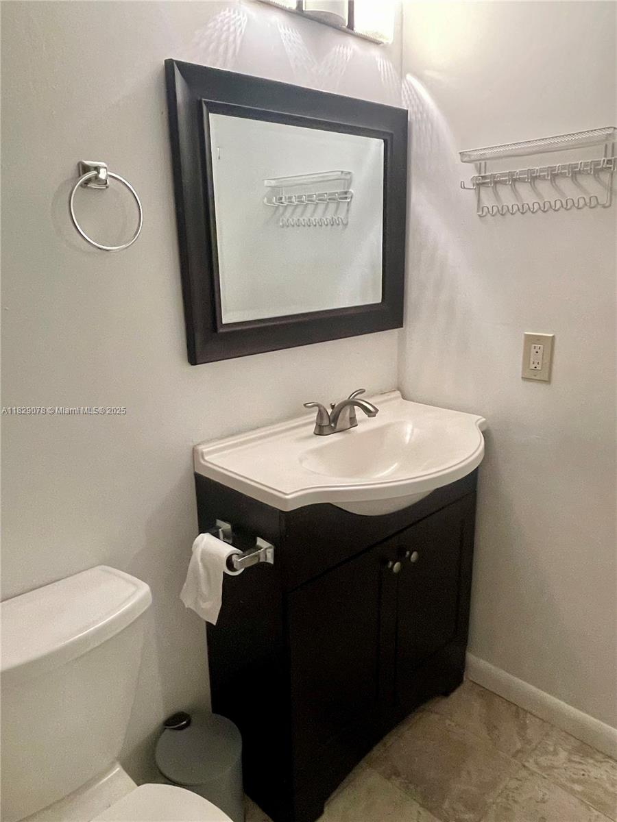 430 Commodore Drive, Unit 301 Plantation, FL 33325 - Photo 20 of 26 a bathroom with a sink and a mirror