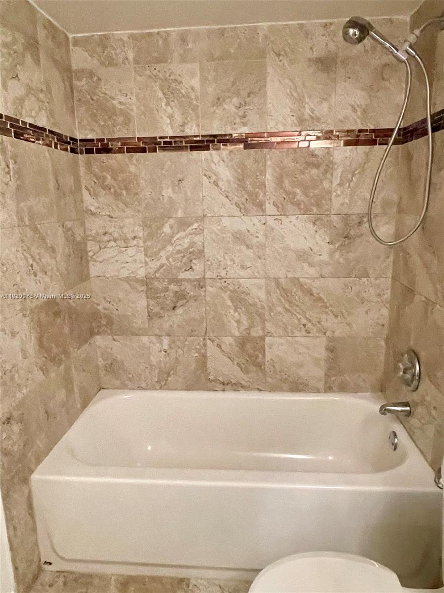 430 Commodore Drive, Unit 301 Plantation, FL 33325 - Photo 21 of 26 a bathroom with a bathtub