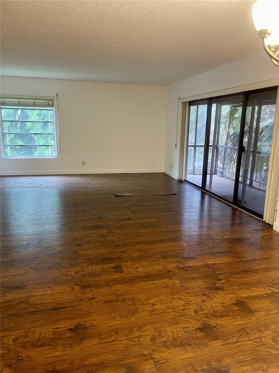 430 Commodore Drive, Unit 301 Plantation, FL 33325 - Photo 4 of 26 a view of empty room with wooden floor and fan