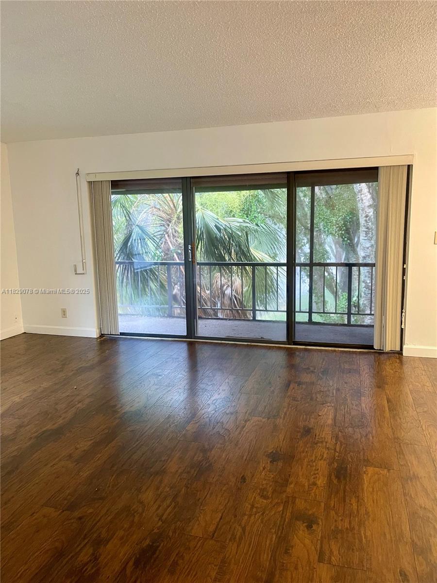 430 Commodore Drive, Unit 301 Plantation, FL 33325 - Photo 5 of 26 a view of an empty room with wooden floor and a window