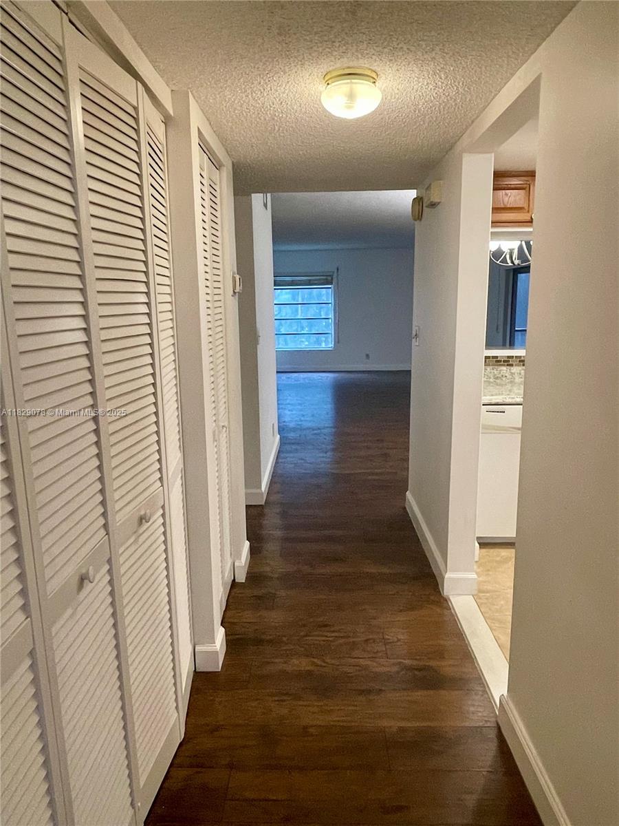 430 Commodore Drive, Unit 301 Plantation, FL 33325 - Photo 6 of 26 a view of a hallway with wooden floor and entryway