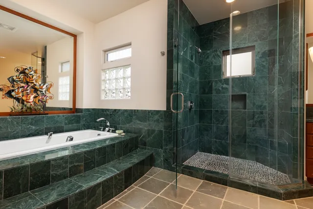 a bathroom with a double vanity sink mirror and shower