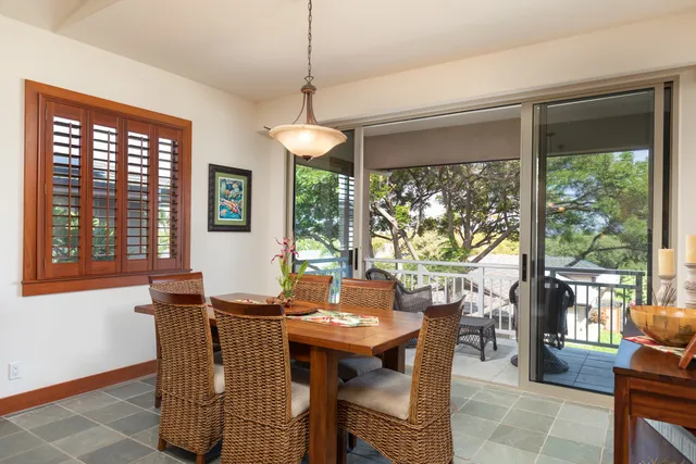 a view of a dining room with furniture large windows and wooden floor