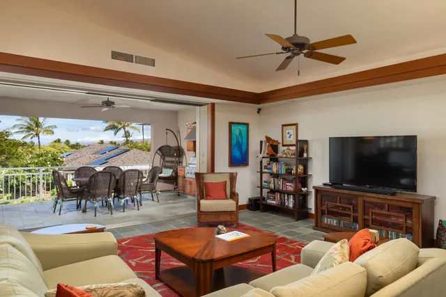 a living room with furniture and a flat screen tv with wooden floor
