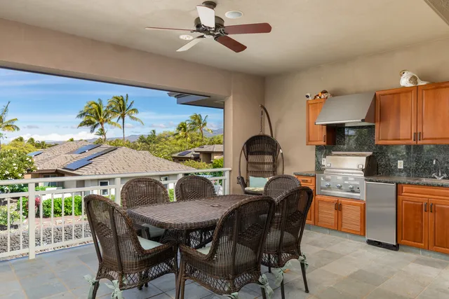 a view of a dining room with furniture and a kitchen