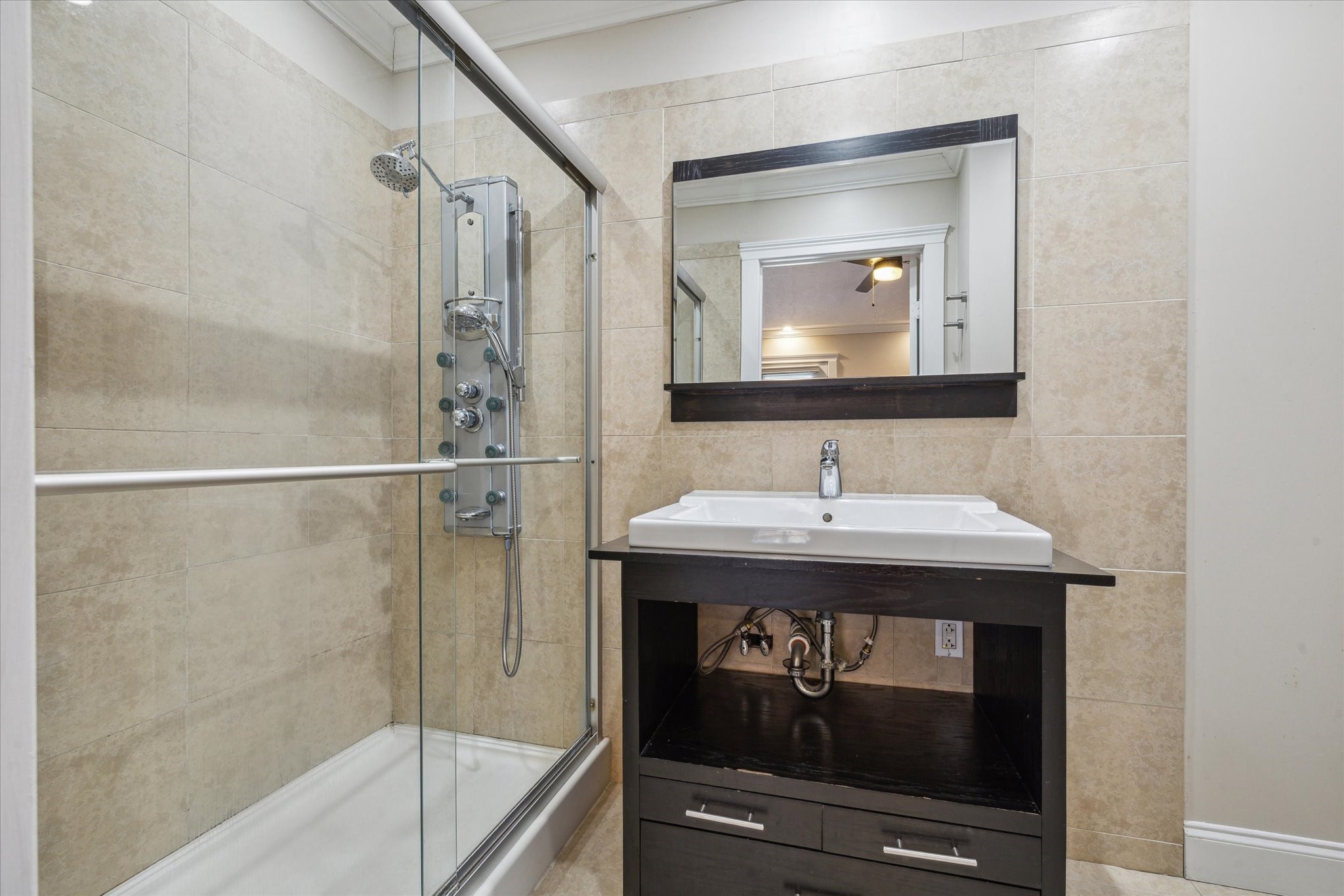 2107 Morgan Street Houston, TX 77006 - Photo 10 of 13 Updated primary bath with modern finishes & spa-inspired glass framed shower.