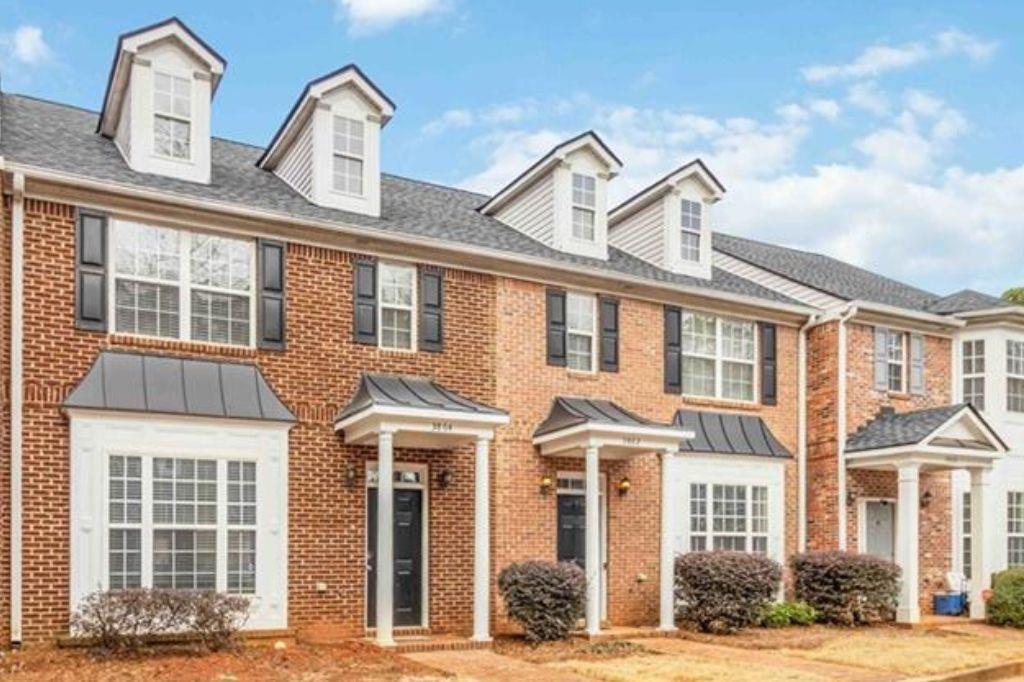 a front view of a building with a garden