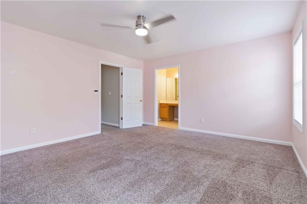 3864 Guilderoy Lane, Unit 3 Austell, GA 30106 - Photo 13 of 27 an empty room with a ceiling fan and a window