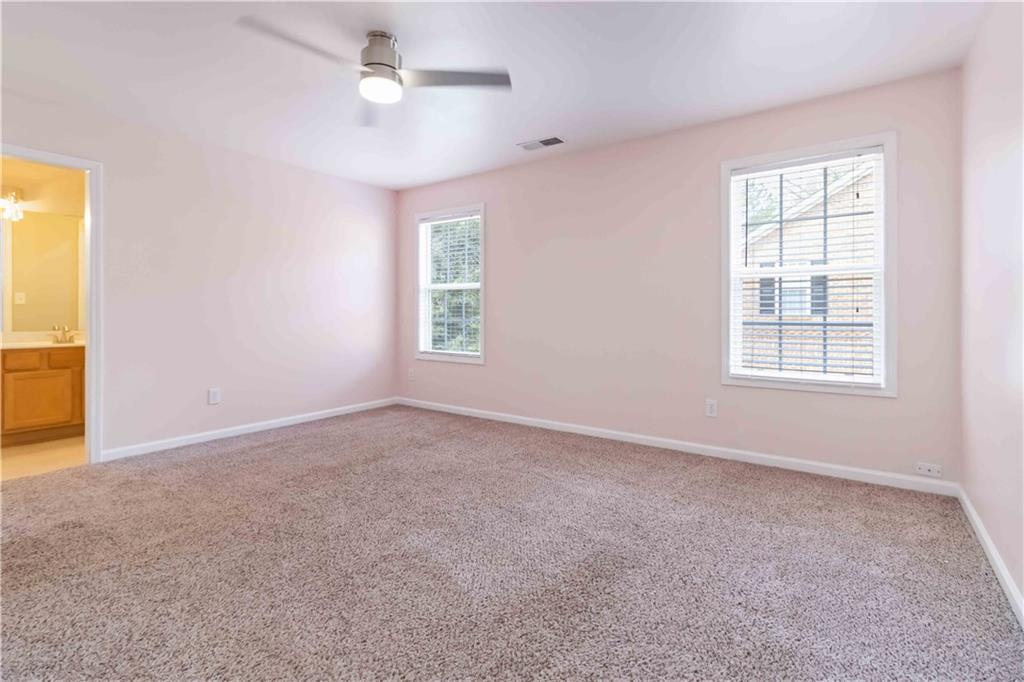3864 Guilderoy Lane, Unit 3 Austell, GA 30106 - Photo 14 of 27 an empty room with windows and fan