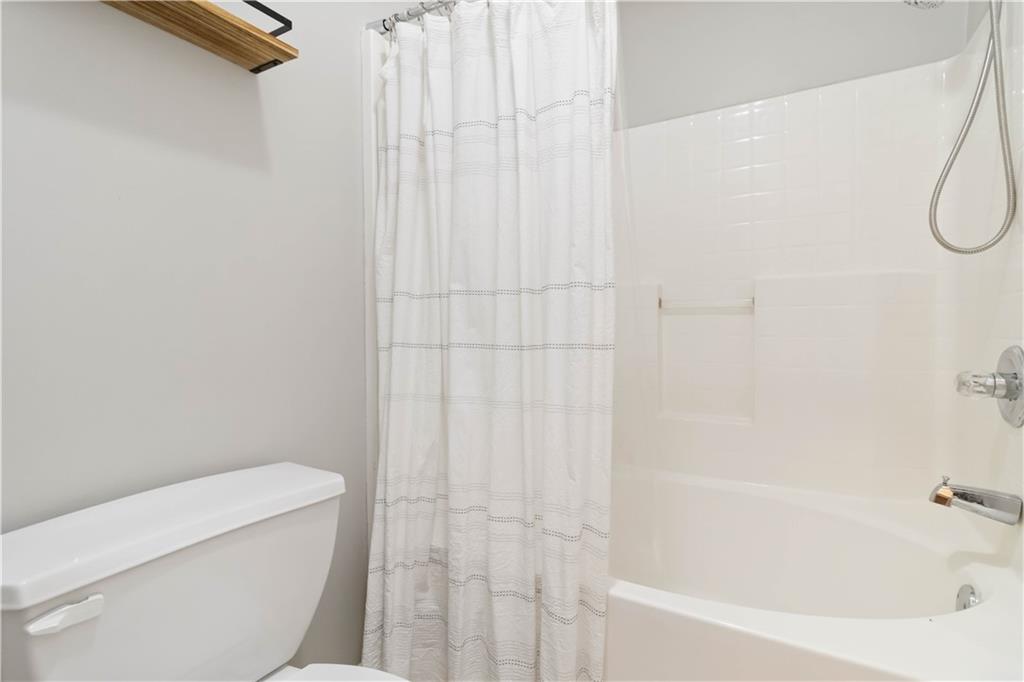 3864 Guilderoy Lane, Unit 3 Austell, GA 30106 - Photo 16 of 27 a bathroom with a shower and a toilet