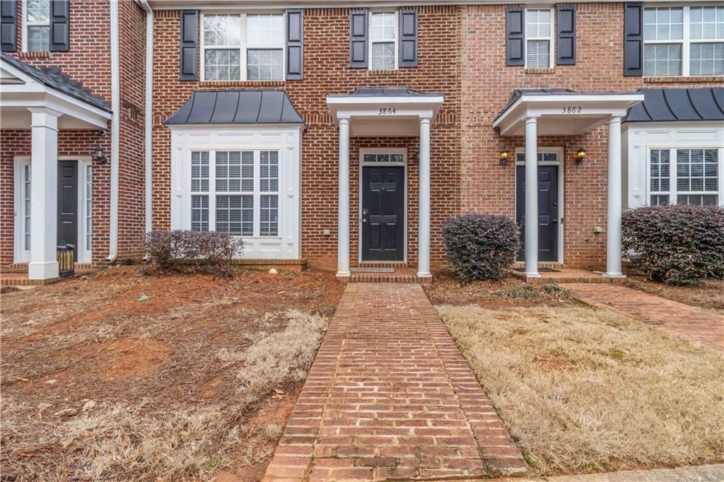 3864 Guilderoy Lane, Unit 3 Austell, GA 30106 - Photo 2 of 27 a front view of a brick house with a yard