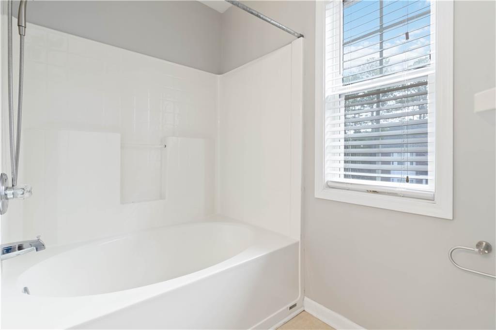 3864 Guilderoy Lane, Unit 3 Austell, GA 30106 - Photo 21 of 27 a white bath tub sitting next to a window