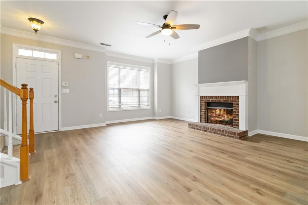 3864 Guilderoy Lane, Unit 3 Austell, GA 30106 - Photo 4 of 27 an empty room with wooden floor fireplace and windows