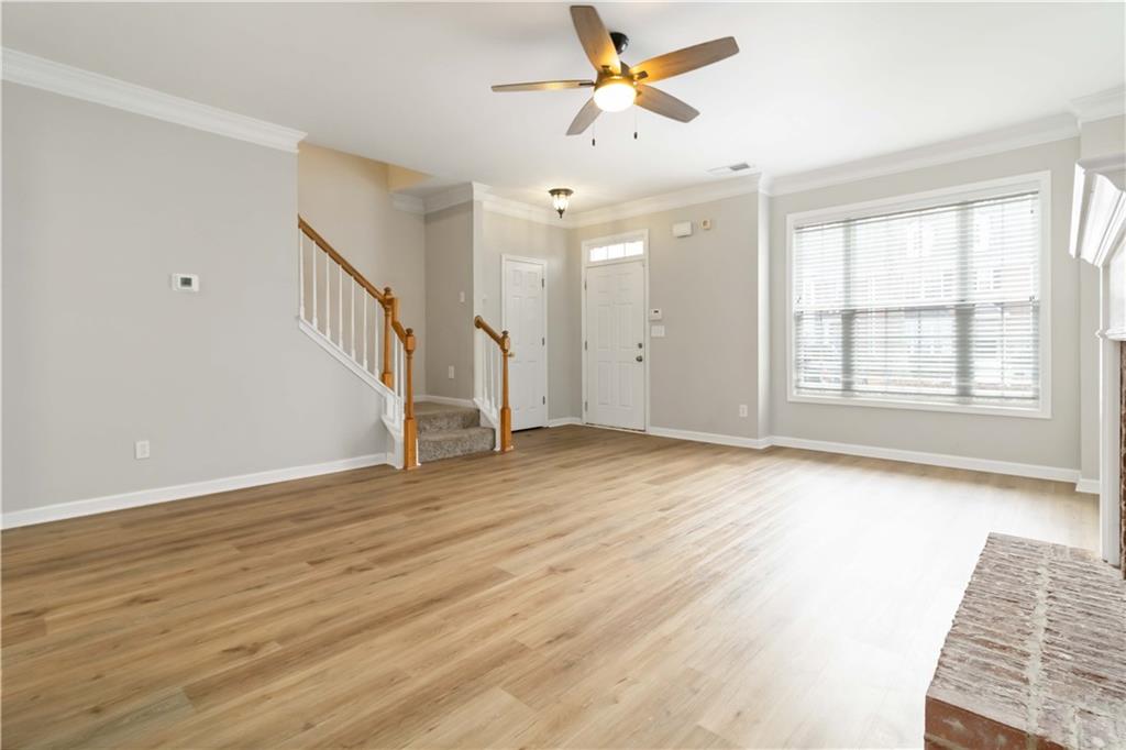 3864 Guilderoy Lane, Unit 3 Austell, GA 30106 - Photo 5 of 27 an empty room with wooden floor fan and windows