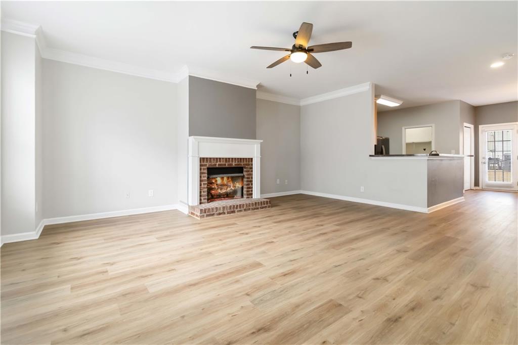 3864 Guilderoy Lane, Unit 3 Austell, GA 30106 - Photo 6 of 27 an empty room with wooden floor and a fireplace
