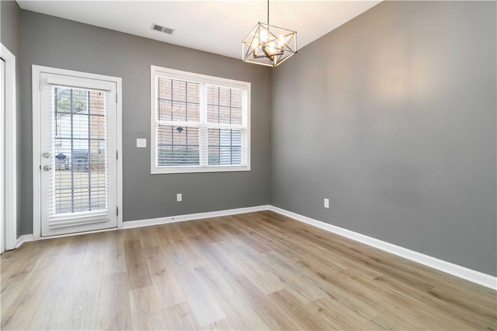 3864 Guilderoy Lane, Unit 3 Austell, GA 30106 - Photo 7 of 27 a view of an empty room with wooden floor and a window