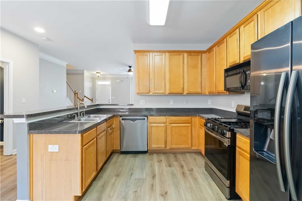3864 Guilderoy Lane, Unit 3 Austell, GA 30106 - Photo 9 of 27 a kitchen with stainless steel appliances granite countertop a sink stove and refrigerator