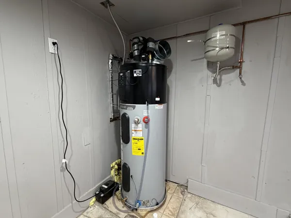 a front view of house with yard and trees in the background