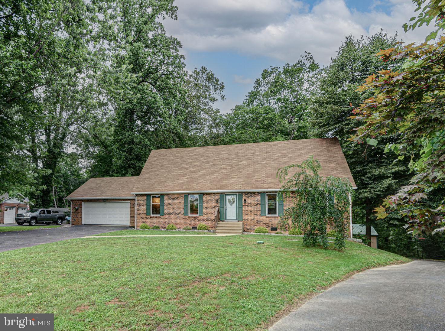 7 Bristle Cone Road Middletown, DE 19709 - Photo 1 of 1 a front view of a house with a garden and trees