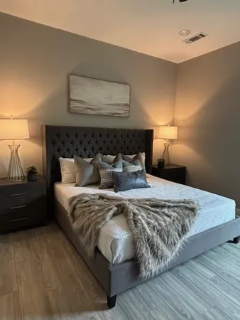 a bedroom with a bed and a night stand