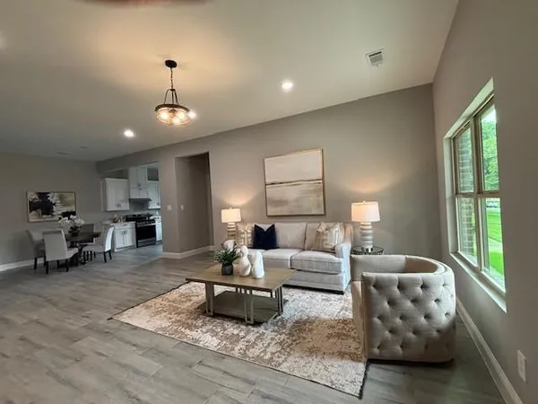 a living room with furniture and a large window