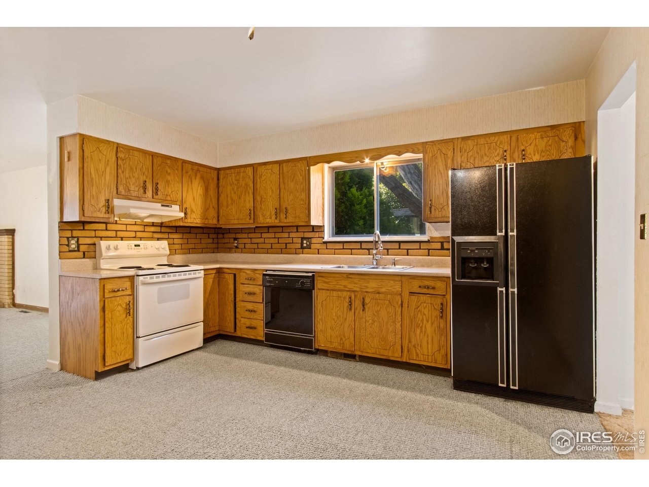 431 West Swallow Road Fort Collins, CO 80526 - Photo 7 of 26 Kitchen with Dishwasher, Electric Range/Oven, Refrigerator/Freezer & Range Hood-Main Level