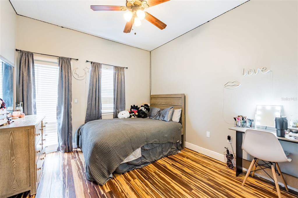 2204 1st Street, Unit F Indian Rocks Beach, FL 33785 - Photo 14 of 37 a bedroom with a bed and wooden floor