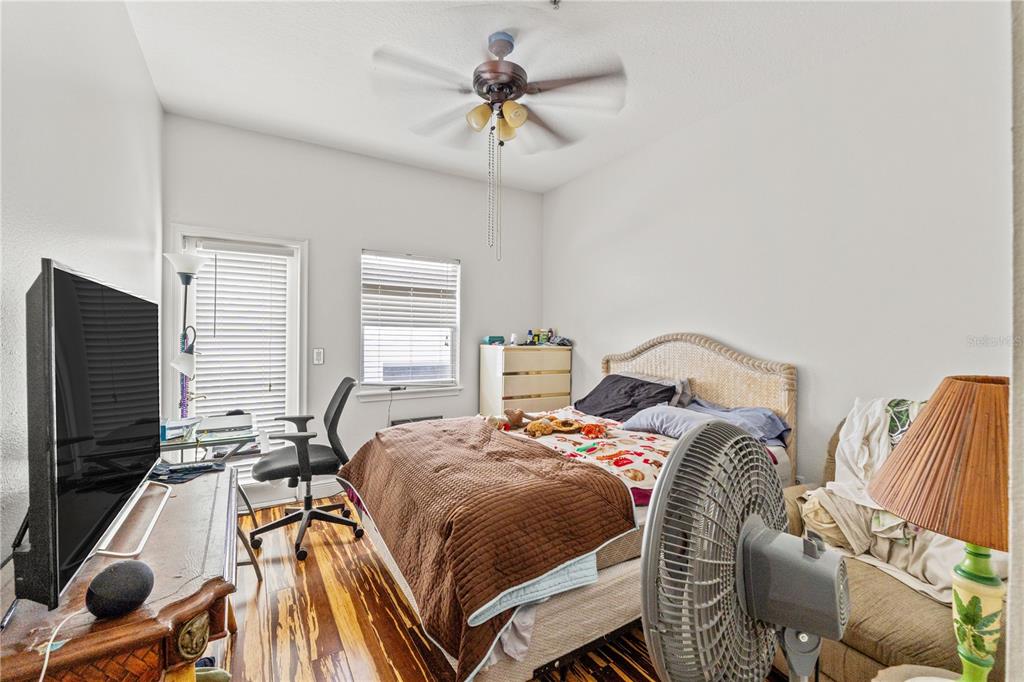 2204 1st Street, Unit F Indian Rocks Beach, FL 33785 - Photo 15 of 37 a bedroom with a bed and a chandelier