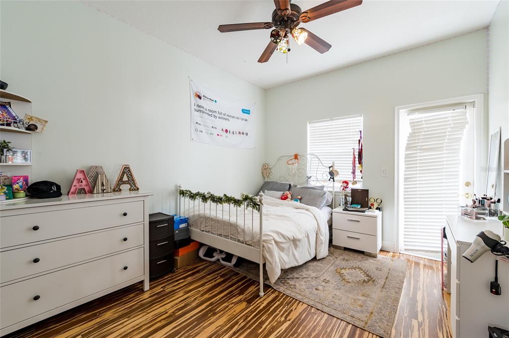 2204 1st Street, Unit F Indian Rocks Beach, FL 33785 - Photo 19 of 37 a bedroom with a bed and a chandelier