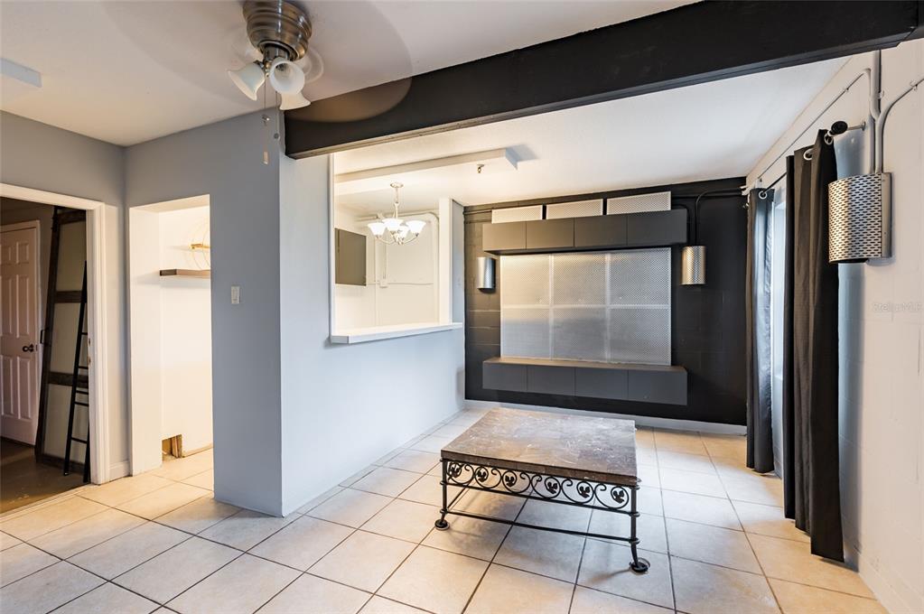 2204 1st Street, Unit F Indian Rocks Beach, FL 33785 - Photo 33 of 37 a view of a hallway with wooden floor and a glass door