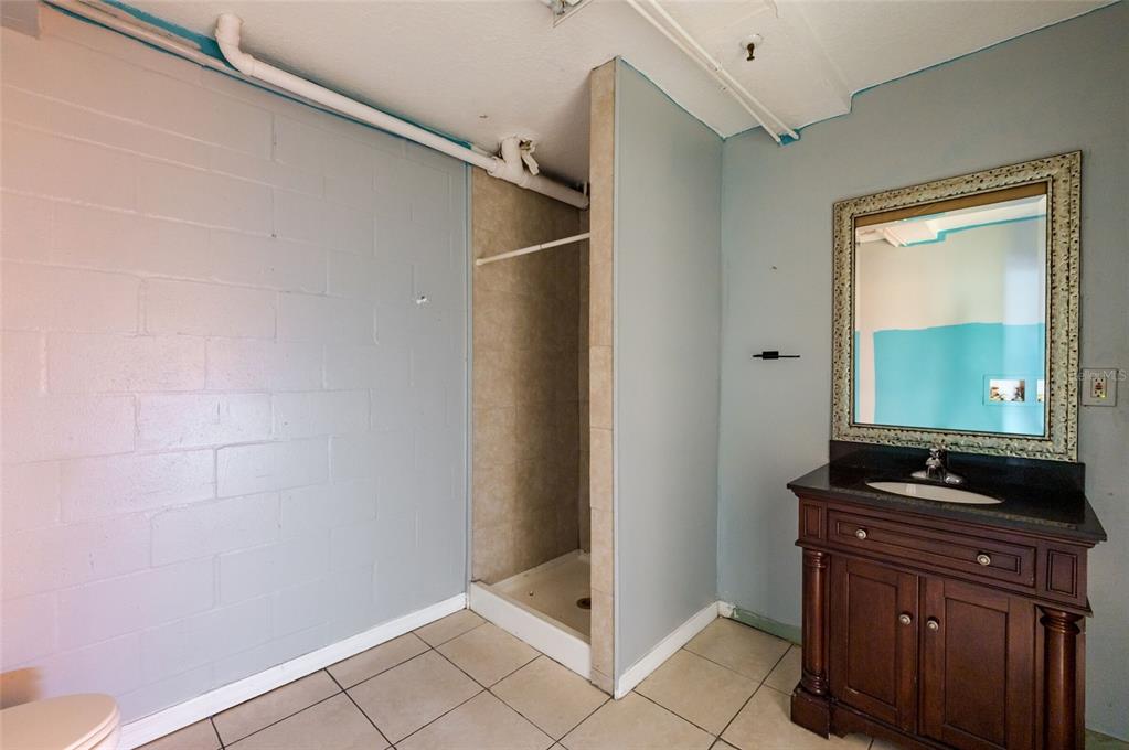 2204 1st Street, Unit F Indian Rocks Beach, FL 33785 - Photo 34 of 37 a bathroom with a sink and a mirror