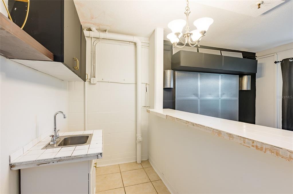2204 1st Street, Unit F Indian Rocks Beach, FL 33785 - Photo 35 of 37 a bathroom with a sink and a mirror