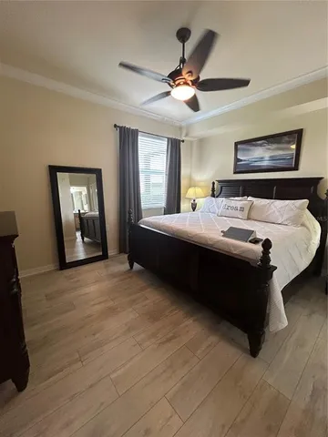 a bedroom with a bed and a chandelier