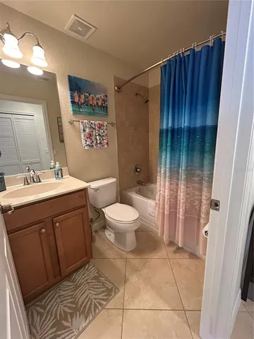a spacious bathroom with a sink toilet and shower