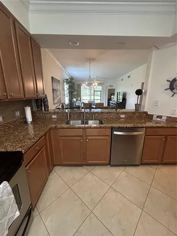 a kitchen with stainless steel appliances granite countertop a stove a sink dishwasher and a refrigerator