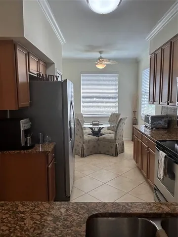 a kitchen with stainless steel appliances granite countertop a refrigerator and a stove