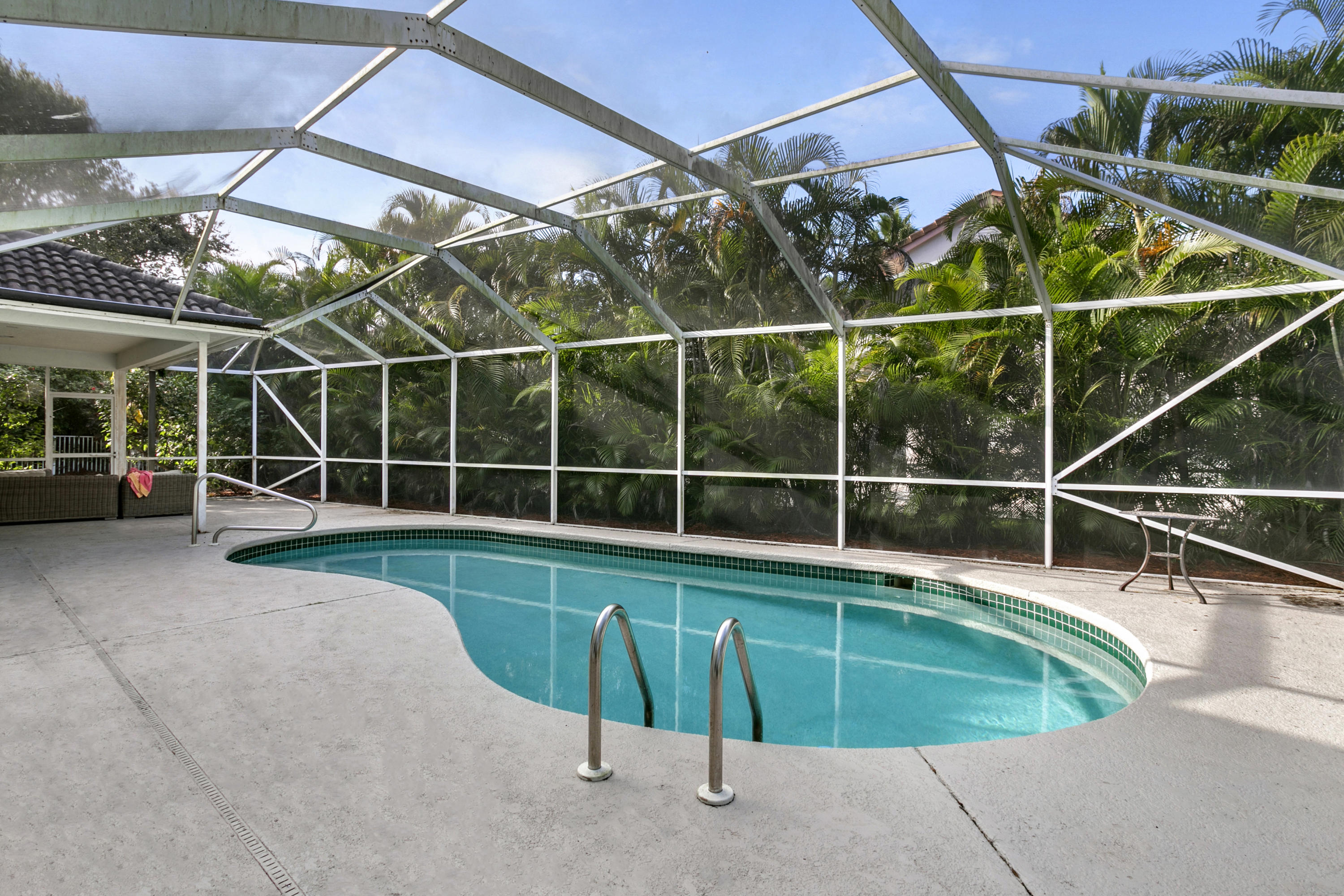 204 Seagull Point Jupiter, FL 33458 - Photo 16 of 18 a view of a swimming pool with a porch