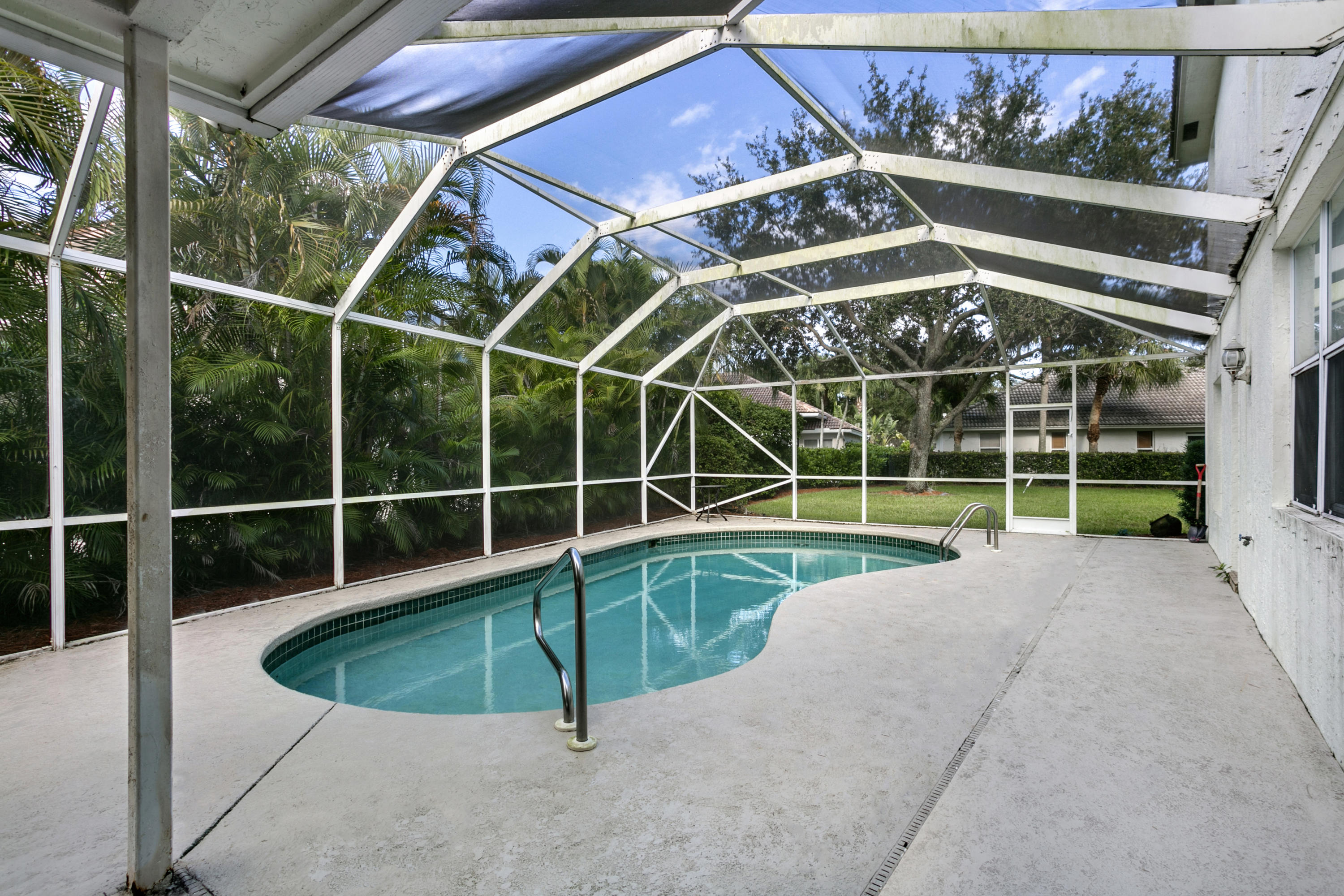 204 Seagull Point Jupiter, FL 33458 - Photo 17 of 18 a view of a backyard with a swimming pool
