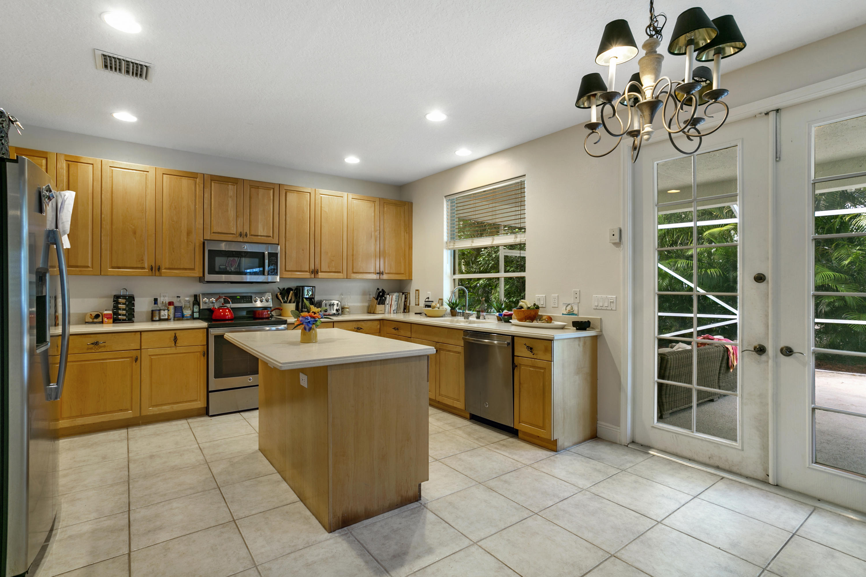 204 Seagull Point Jupiter, FL 33458 - Photo 3 of 18 a kitchen with a sink window and stainless steel appliances