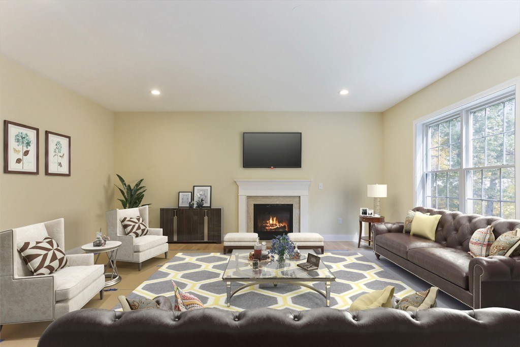 76 Box Turtle Drive Rochester, MA 02770 - Photo 11 of 12 a living room with furniture a fireplace and a flat screen tv