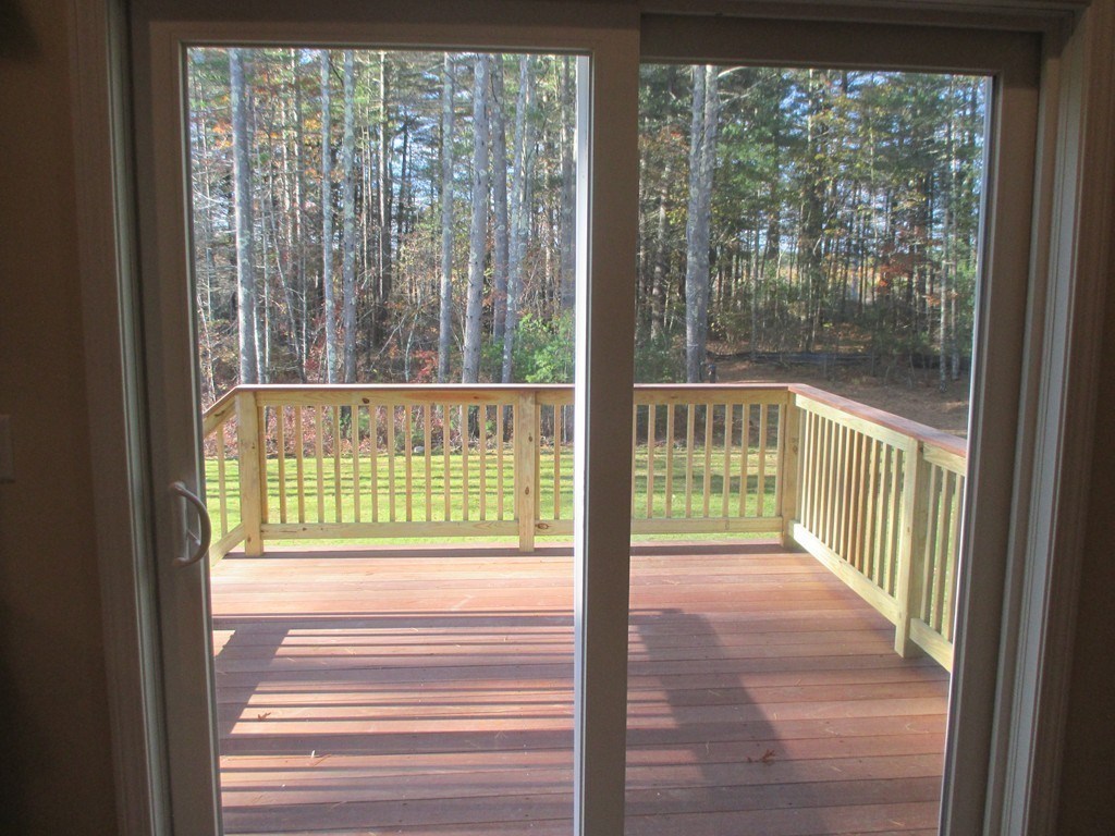 76 Box Turtle Drive Rochester, MA 02770 - Photo 12 of 12 a view of a room with wooden floor and a porch
