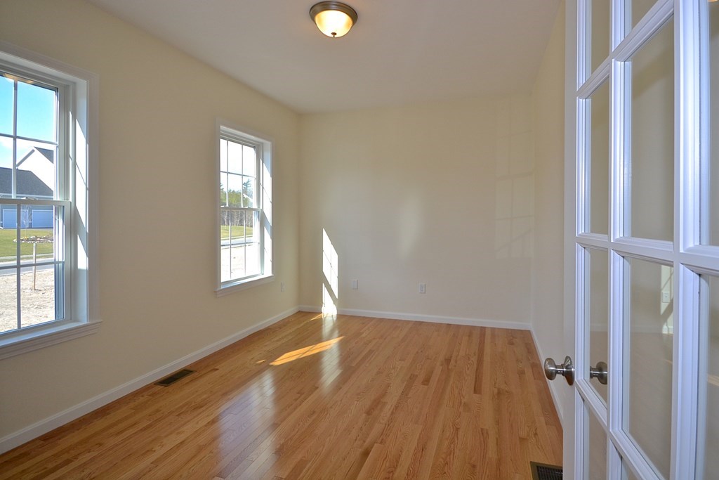 76 Box Turtle Drive Rochester, MA 02770 - Photo 2 of 12 an empty room with wooden floor and windows