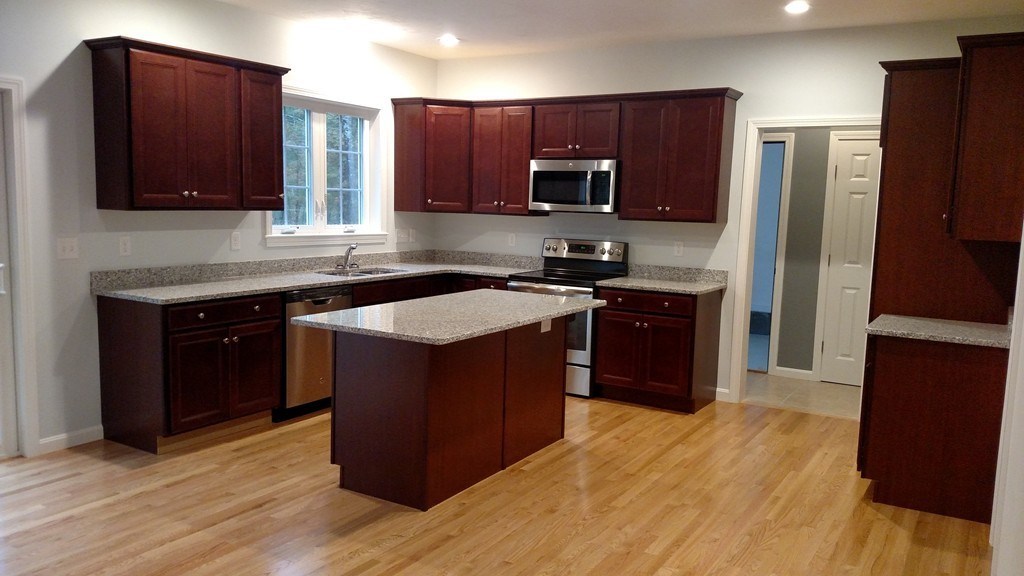 76 Box Turtle Drive Rochester, MA 02770 - Photo 7 of 12 a kitchen with stainless steel appliances granite countertop a stove a sink dishwasher a refrigerator and a microwave oven